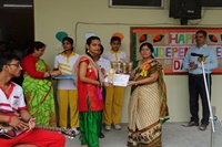 Honourable Manager ma'am awarding the student